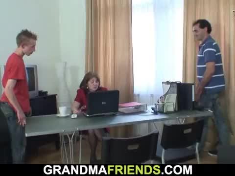 Granny boss swallows two cocks on work area